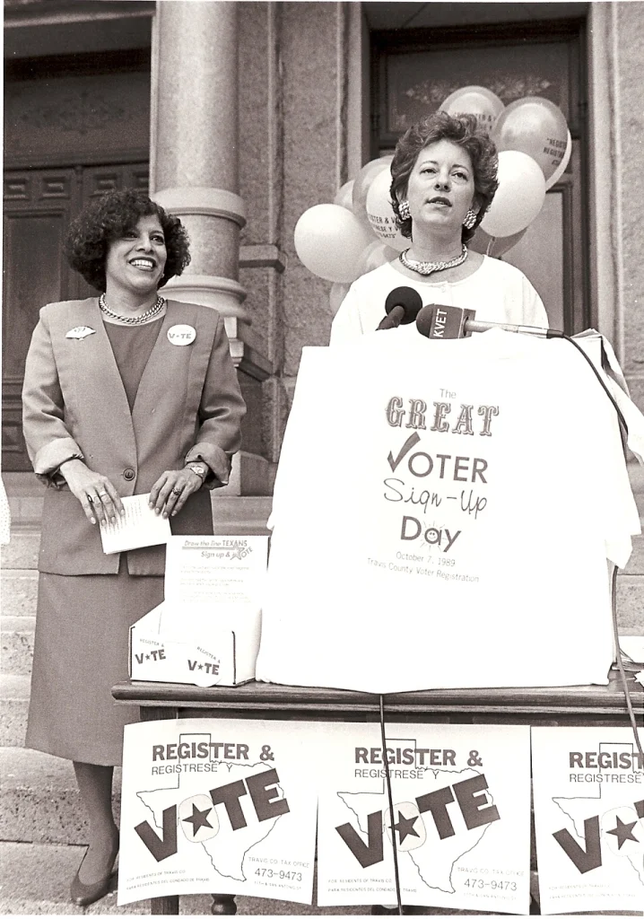 Amalia Rodriguez-Mendoza and Tax Assessor Collector Cecelia Burke at a voter registration drive, 1989. Amalia Rodriguez-Mendoza, later the District Clerk, was the Voter Registrar at the time. Travis County Archives.