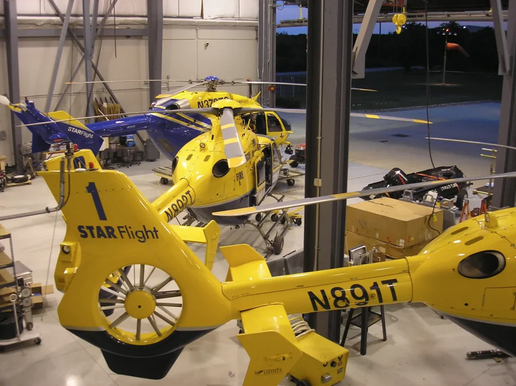 EC135s and EC145 helicopters in hangar